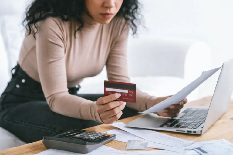 how to improve credit score fast stressed woman checking bills and credit card at home