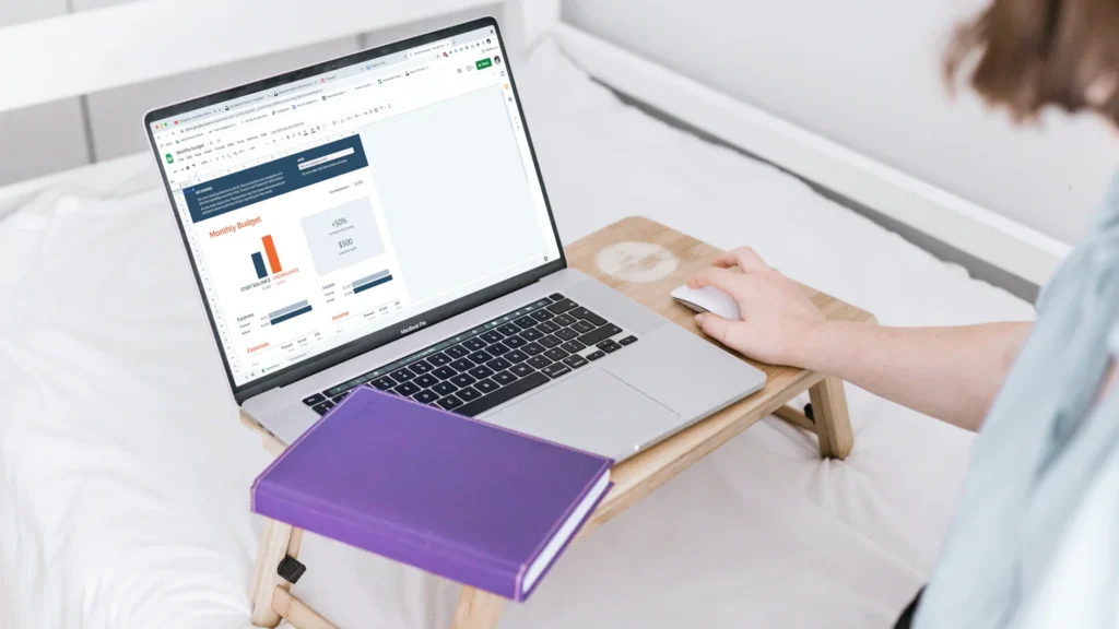 Woman reviewing a household budget while comparing debit and credit-building options