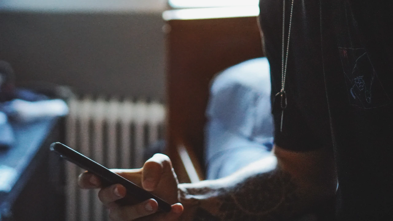 Person holding a smartphone indoors