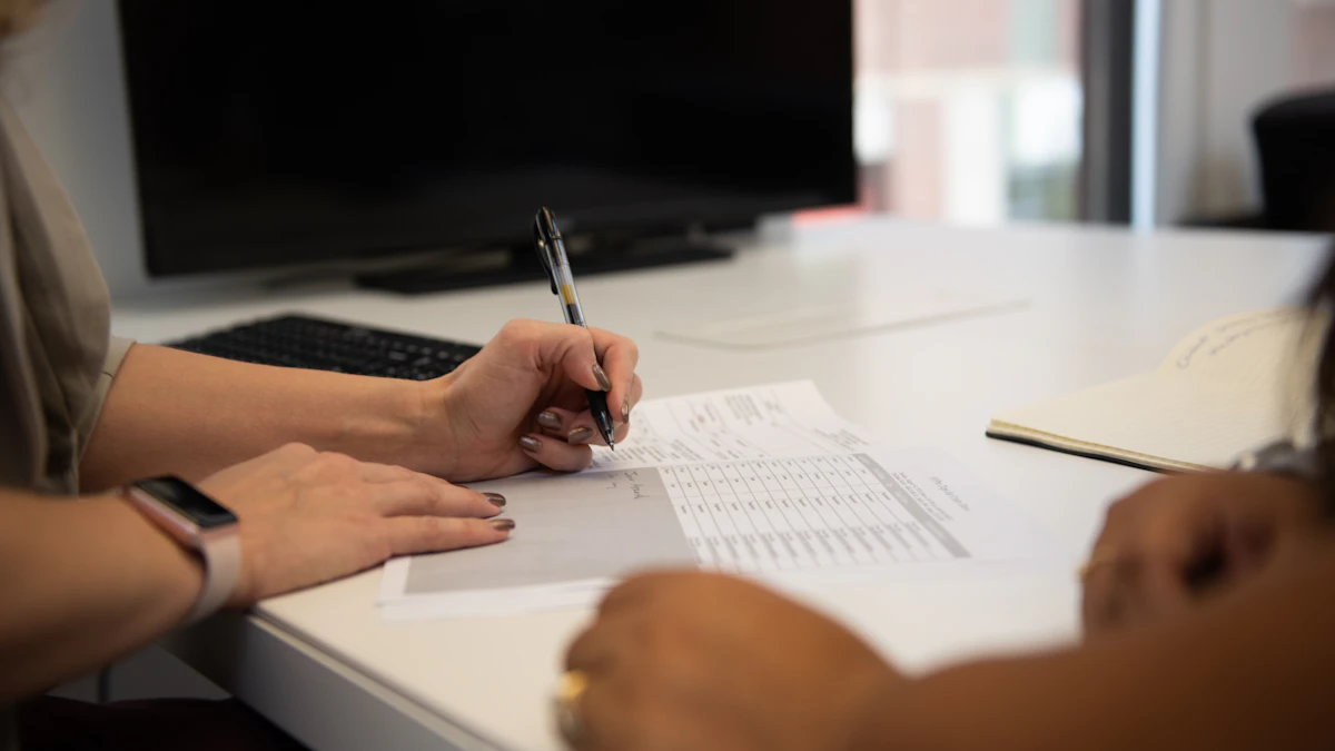 Woman preparing paperwork at a desk while writing notes for a financial review
